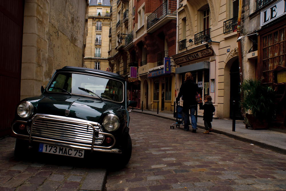 Mini Cooper on the old brick streets of Paris.